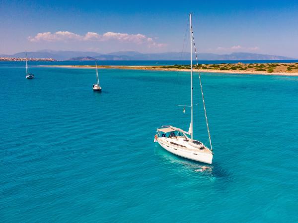 Family swimming in turquoise seas on a flotilla sailing holiday in Greece