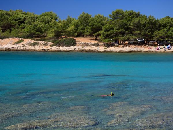 Person snorkelling close to Murter island in Croatia