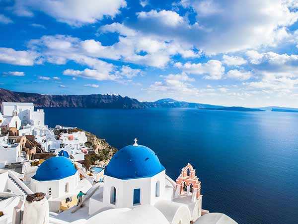 Famous blue domes of churches in Oia city on Santorini island, Greece