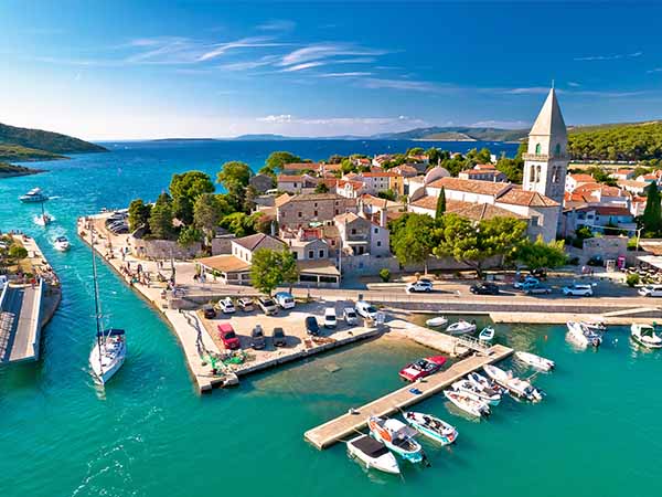 Aerial view of yachts sailing near the town of Osor, Croatia. Bridge between Cres and Mali Losinj islands, Adriatic archipelago of Croatia. 